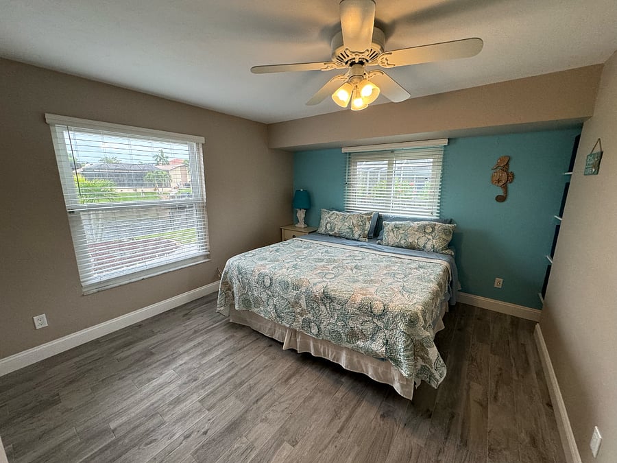Bedroom off of living room, king bed and closet within bedroom