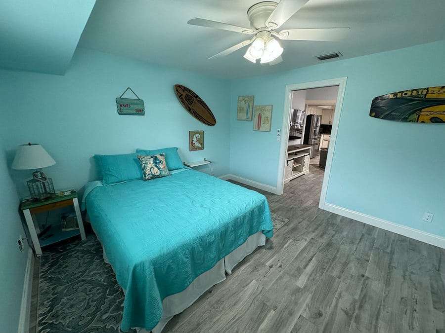 Bedroom just off of living room, looking through door for perspective. Queen bed