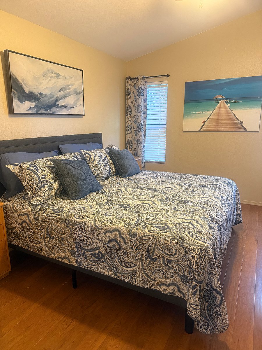 Master bedroom with king size bed and ensuite bathroom.