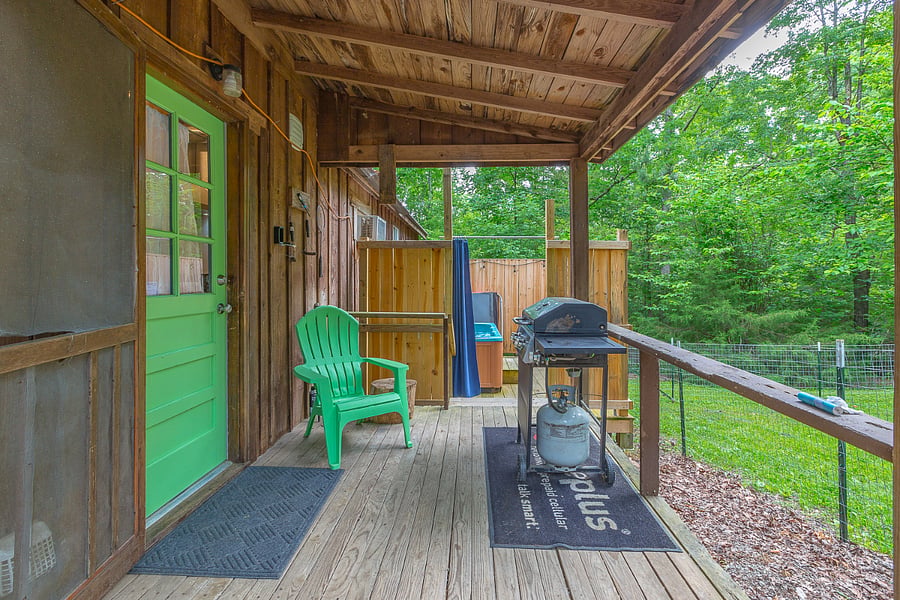 Gas Grill outside kitchen door with hot tub in background