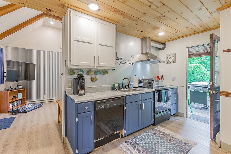 Another view of kitchen with living room and back porch in thebackground