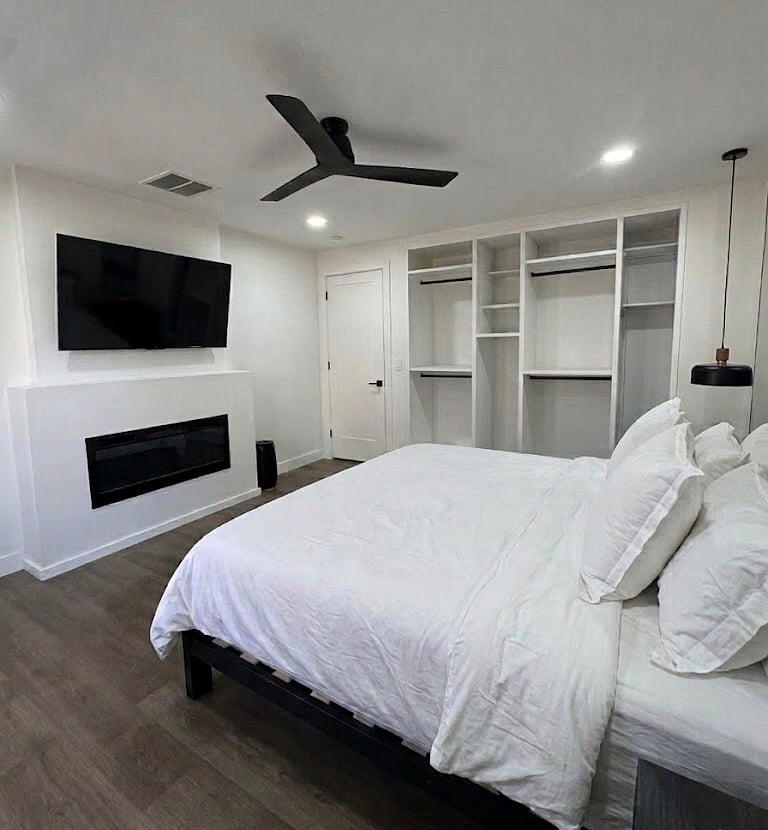 Bedroom #3: Open concept closet. Clothes basket. In suite smart TV. In suite LED fireplace. King bed. Double doors to back patio.