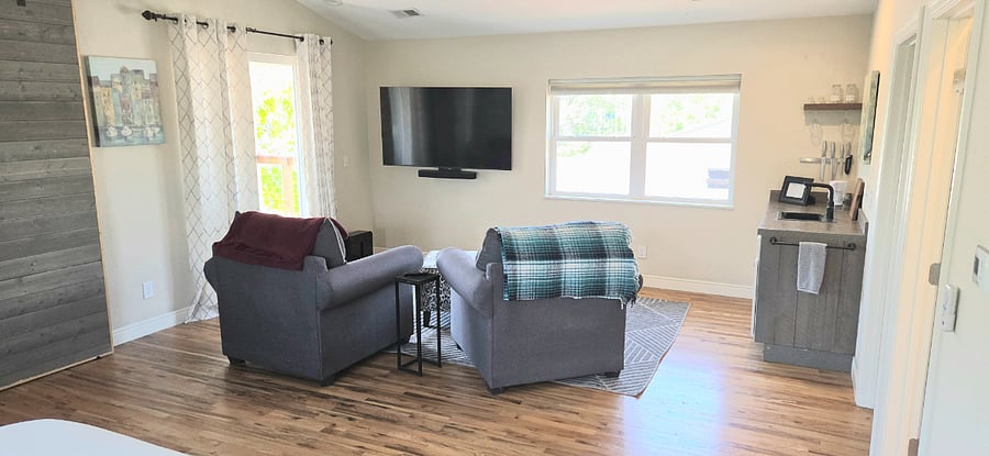 Luxury suite lounge area with 65" smart TV with Sonos Beam and Sub