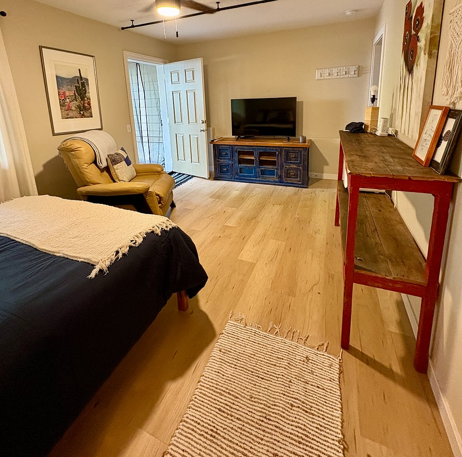 TV, recliner, shelves with baskets for storage