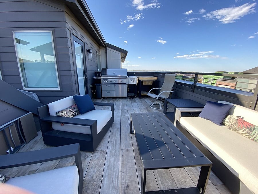 L-shaped 4th floor rooftop patio with RH furniture & Lynx natural gas grill.