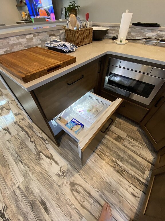 SubZero freezer drawer with ice-maker. Refrigerator drawer above. Microwave on the right. Bosch dishwasher further to the right (not in photo).