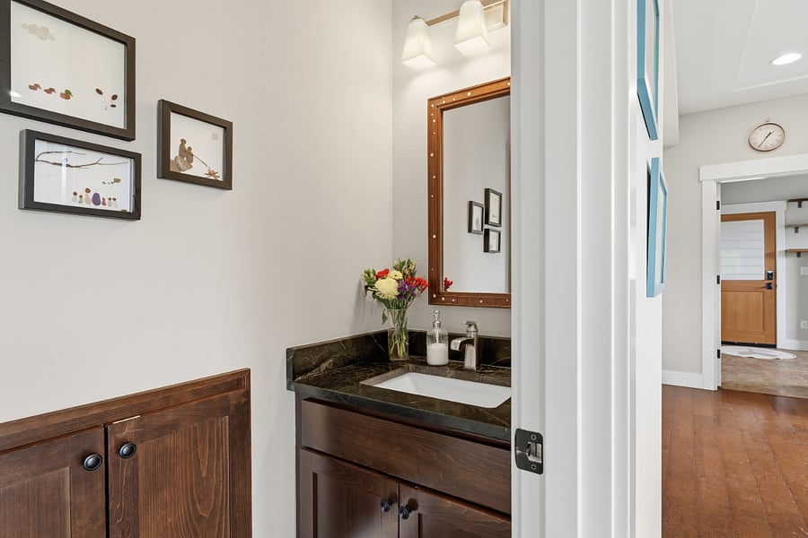 Powder room with custom art located downstairs