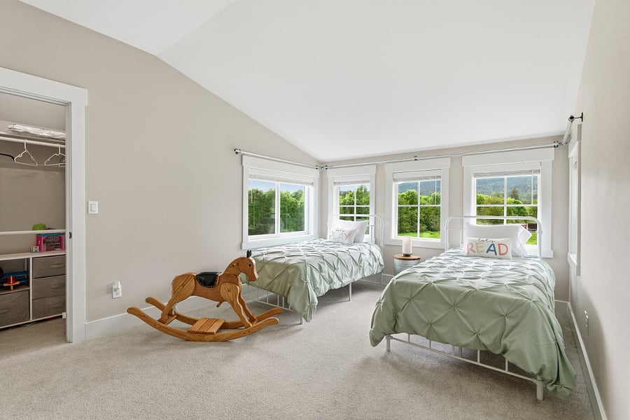 Bedroom 3, two twin beds, walk in closet, wood blinds. 