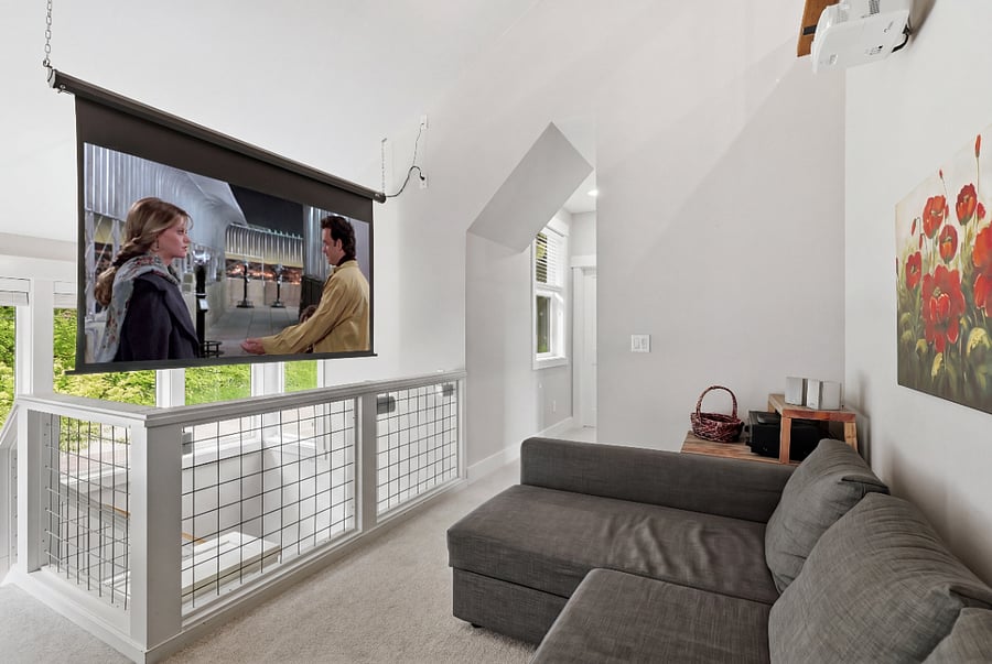 Upstairs sitting area converts to movie theater with surround sound