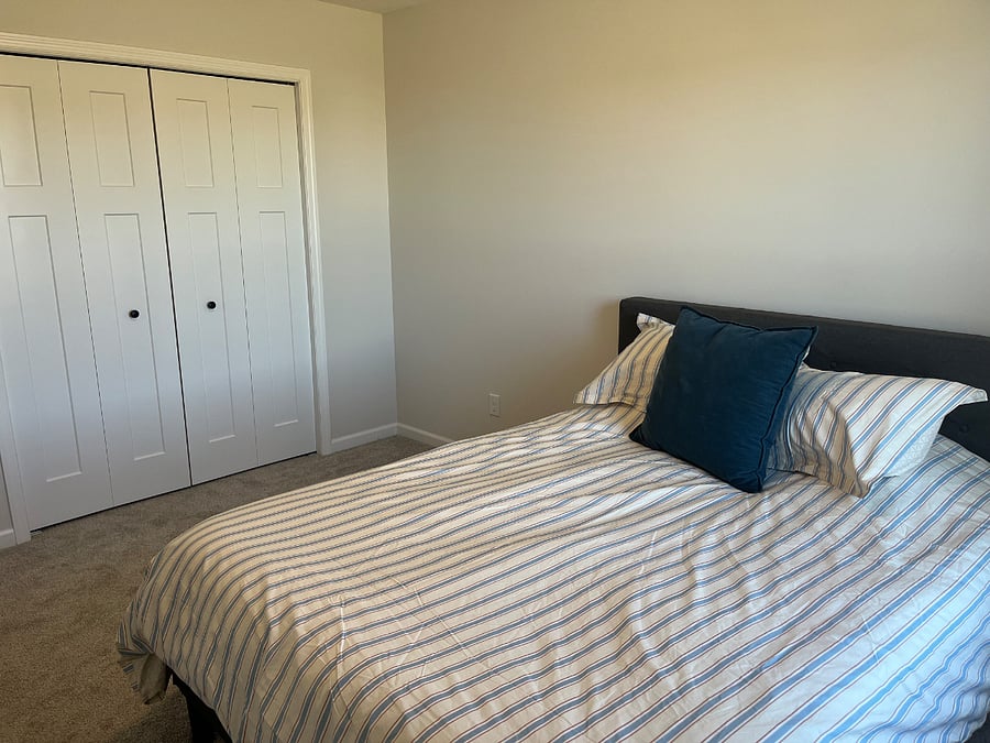 Closet in bedroom with shelves above for additional storage.