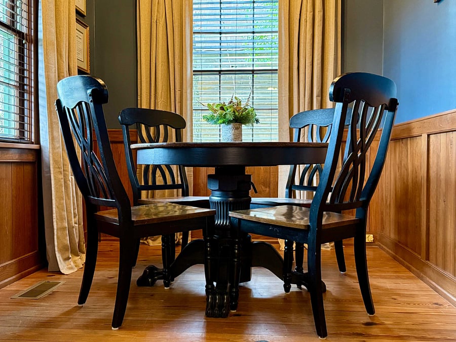 An antique table, local artwork, and vintage photographs outfit the separate dining area, which can also double as a workspace.