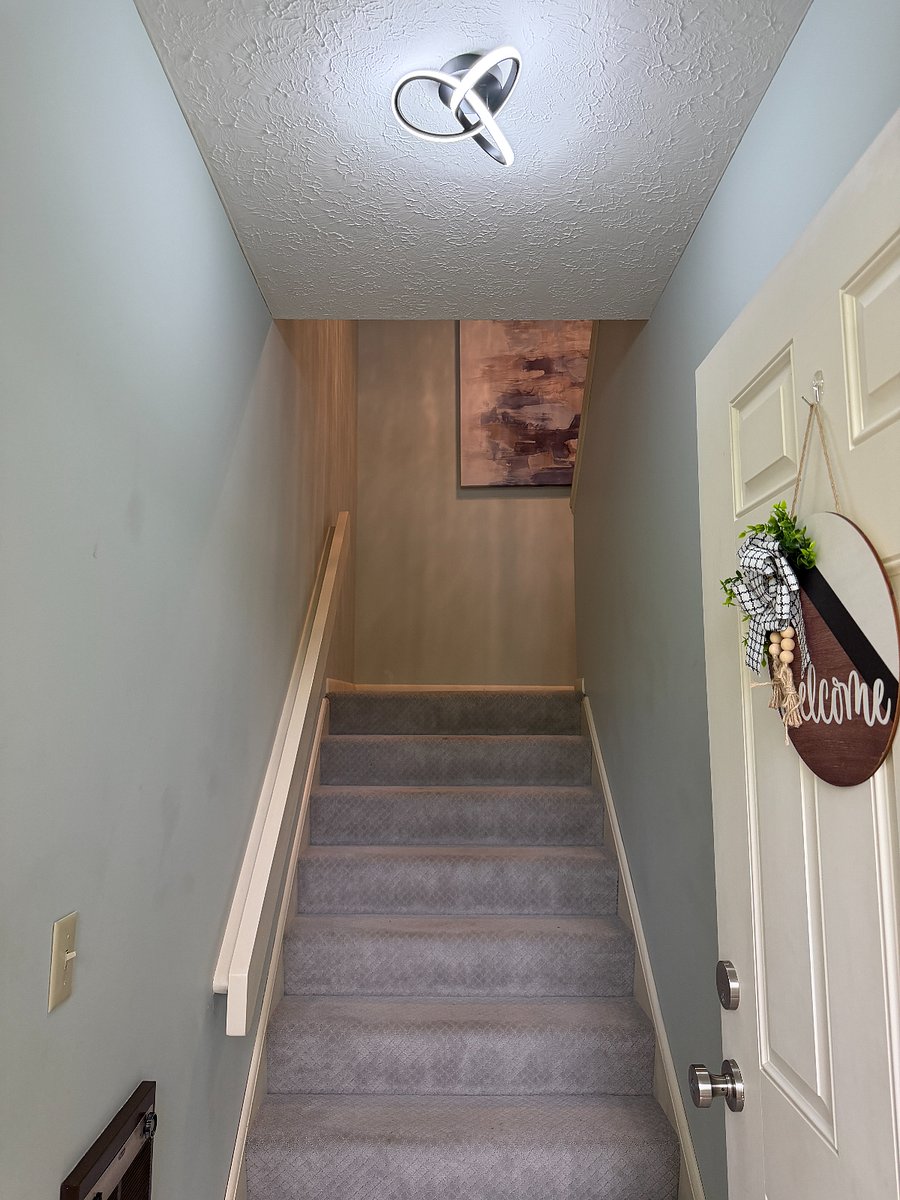 Front door, foyer and stairway into the condo