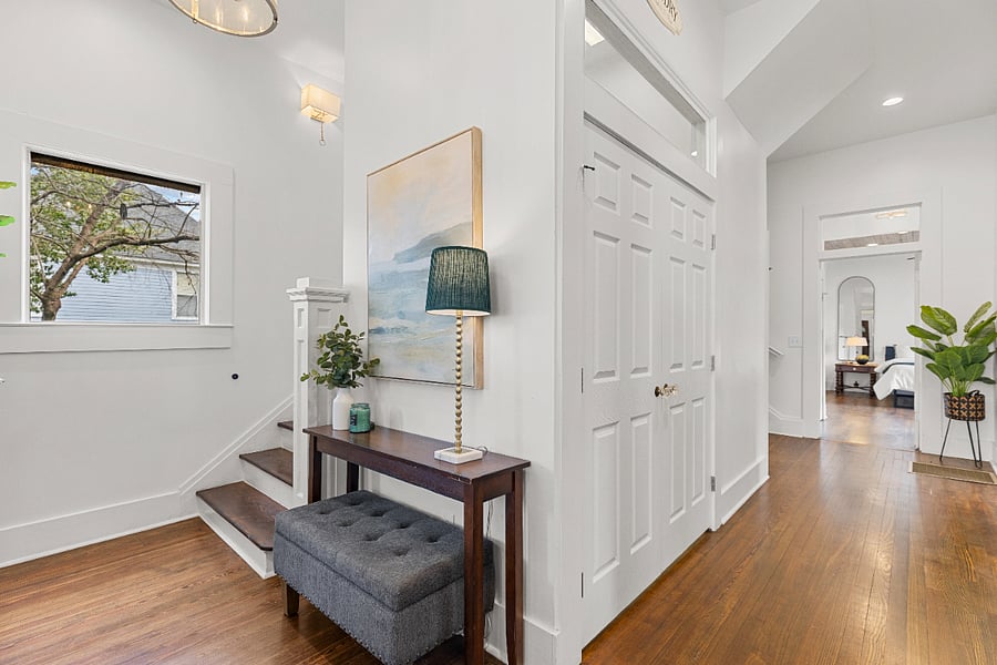 Entryway with double staircase that also leads from kitchen.