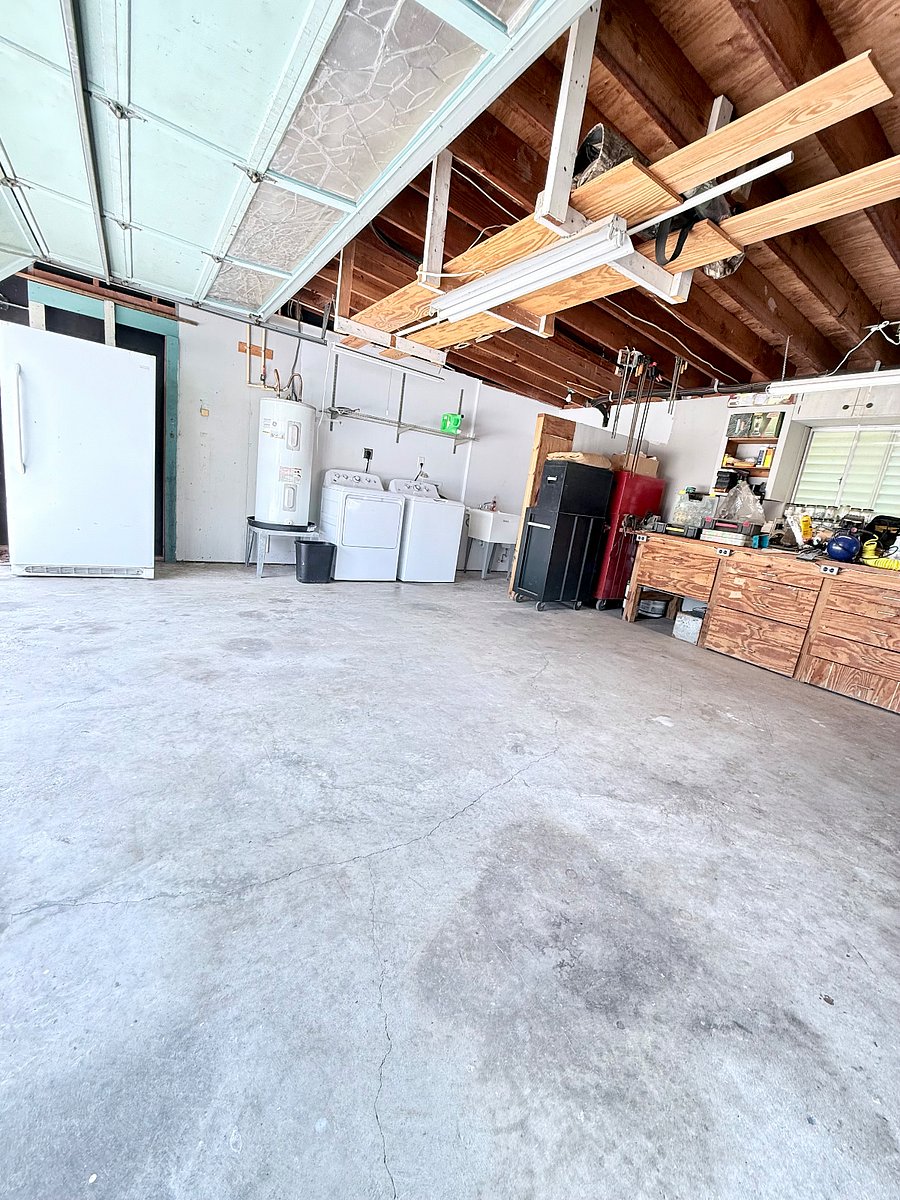 Garage with washer & dryer , utility sink, looking out into the back yard.