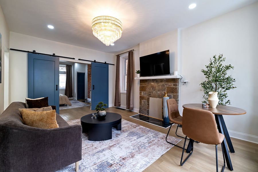 Living Room with Barn door and Chandelier.