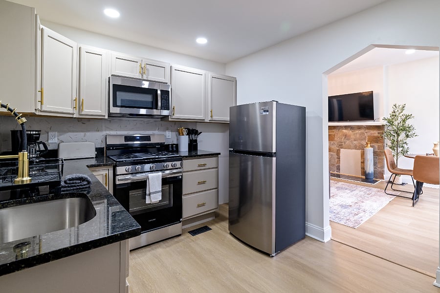 Kitchen with fridge, stove, and microwave.
