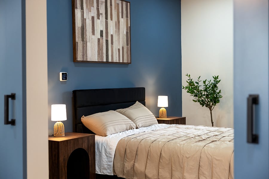 Bedroom with nightstands and themostat