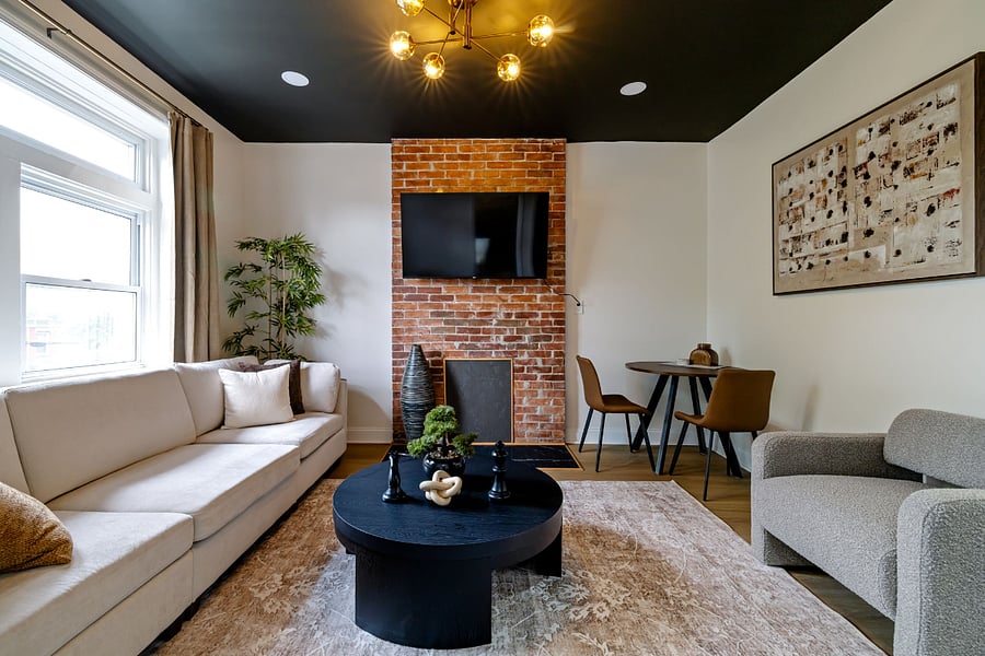 Living room with sofa, Smart TV, and accent chair with reading lamp.