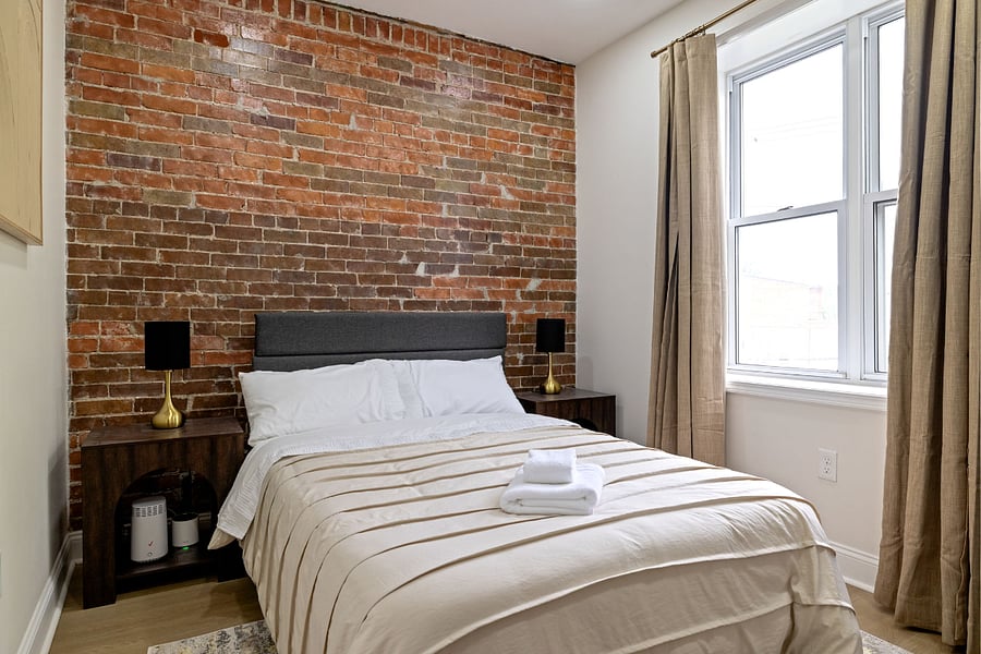 1st bathroom with full size bed and nightstands.