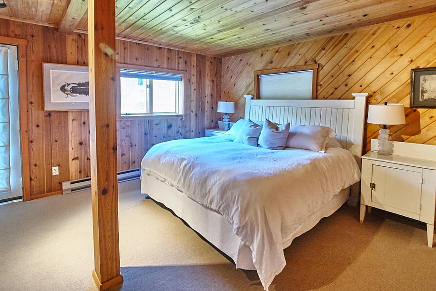 King bed master bedroom on lower/basement level with walk out door to backyard