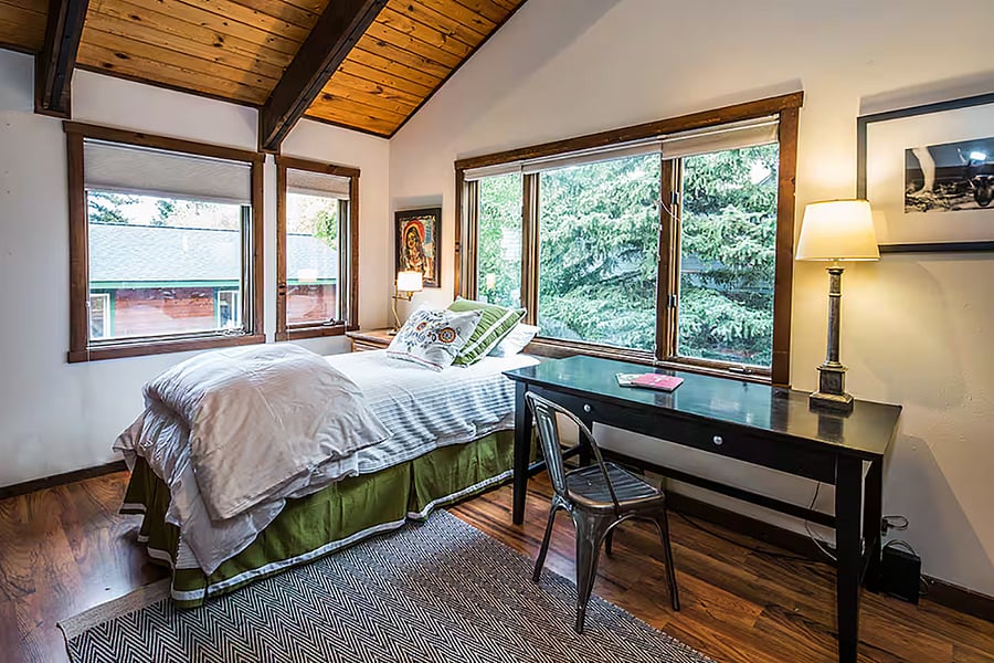Library room behind kitchen, main level . Twin bed, built in bookshelves, closet and desk. Could move an extra twin up from the bunk room for 2 twins
