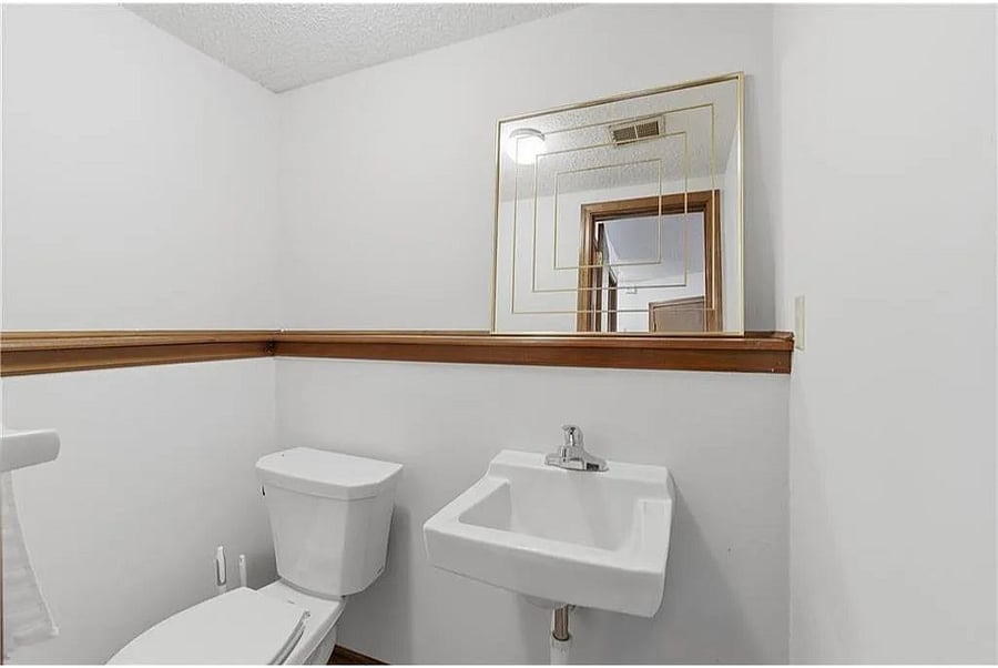 Simple and clean half bathroom featuring modern touches, bright finishes, and a fresh welcoming feel.
