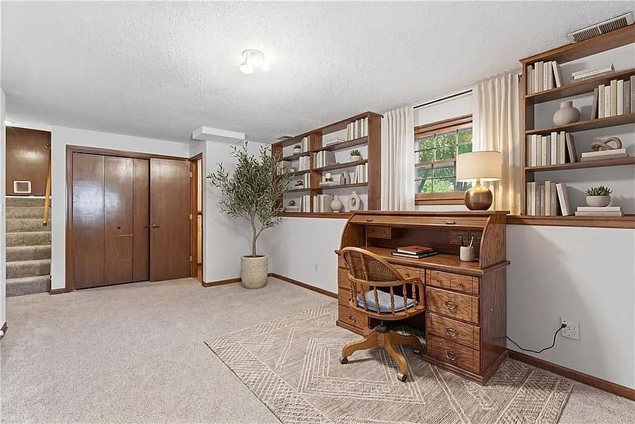 Cozy workspace with built in shelving, warm wood finishes, and plenty of room for productivity and focus.