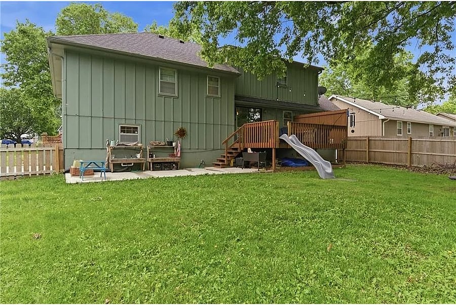 Spacious outdoor area featuring a private deck and large yard ideal for entertaining, enjoying fresh air, or spending time with family and friends.