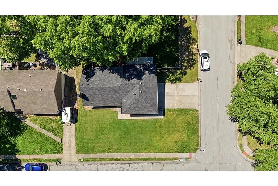 Top down aerial view displaying the propertys spacious layout, generous outdoor areas, and inviting neighborhood environment perfect for both short and extended stays.