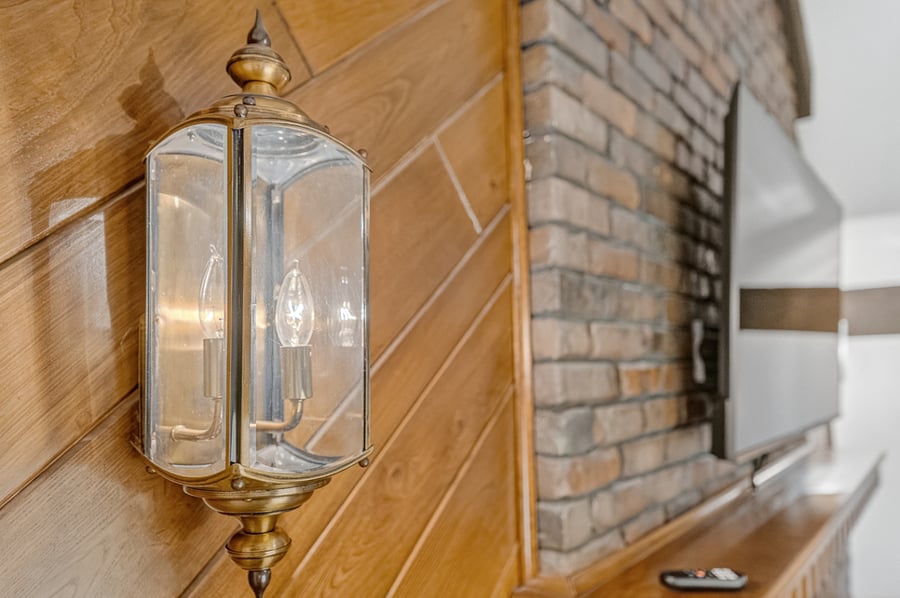 Rustic fireplace detail featuring warm wood accents, exposed brick, and charming vintage character.
