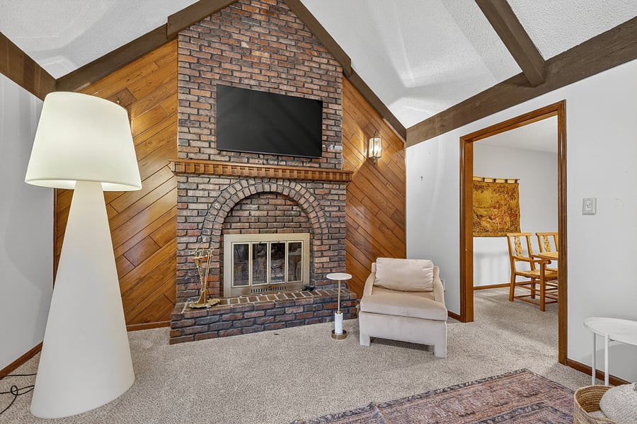 Charming fireplace lounge with rustic wood accents and comfortable seating for cozy evenings indoors.
