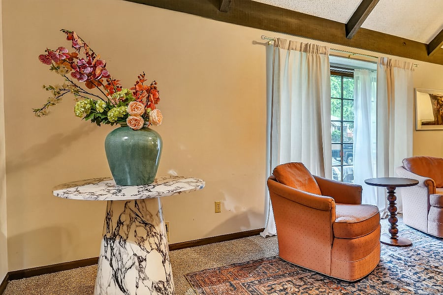 Thoughtfully styled sitting area featuring warm tones, natural light, and tasteful decorative touches.