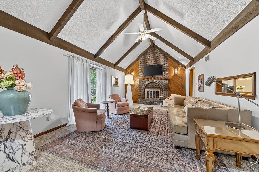 Wide angle view of the inviting great room showcasing vaulted ceilings and a spacious open layout.