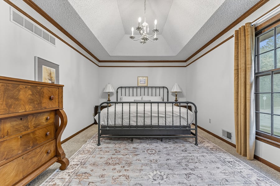 Spacious primary bedroom with elegant finishes, soft lighting, and a relaxing atmosphere for restful nights.