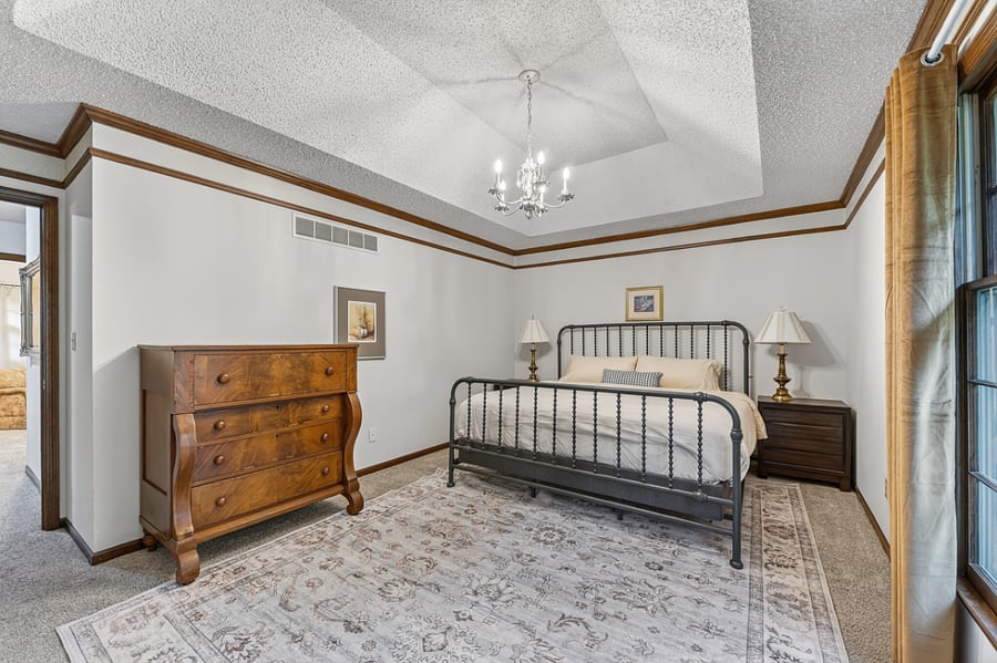Spacious primary bedroom with elegant finishes, soft lighting, and a relaxing atmosphere for restful nights.
