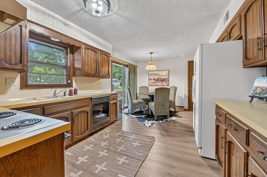 Functional galley style kitchen with generous storage, modern appliances, and easy open access.