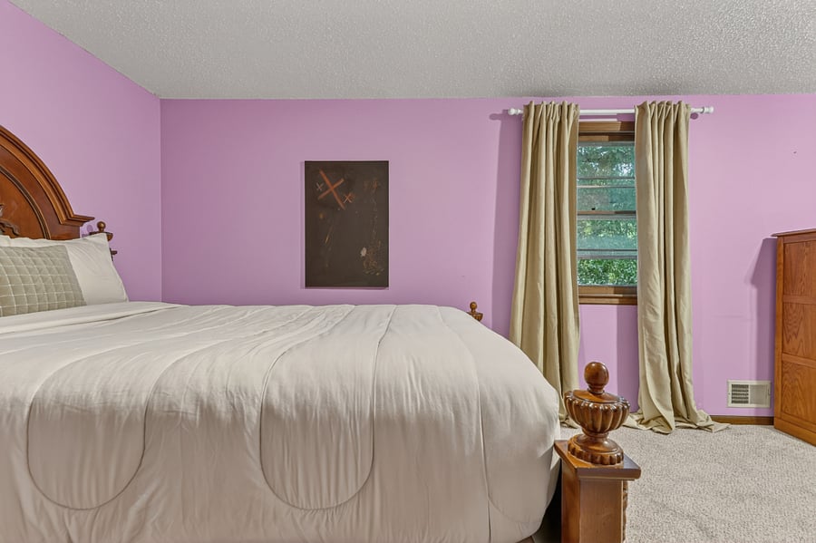 Cozy bedroom corner with warm natural light, soft curtains, and a relaxing home like ambiance.