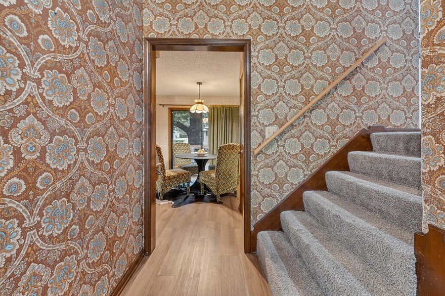 Cozy hallway and staircase area with charming wallpaper and classic home character throughout.