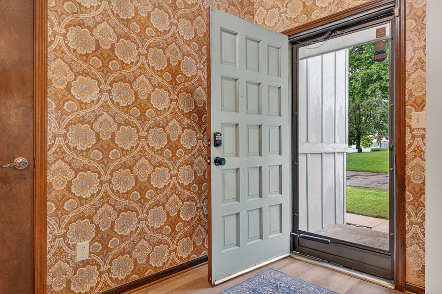 Inviting front doorway with timeless details and a bright open entrance into the home.