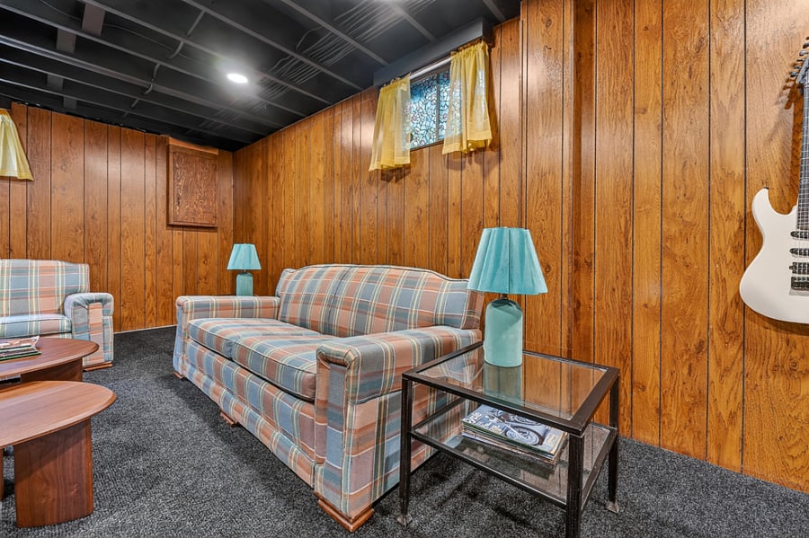 Comfortable basement seating area with warm wood finishes and a cozy relaxed atmosphere.