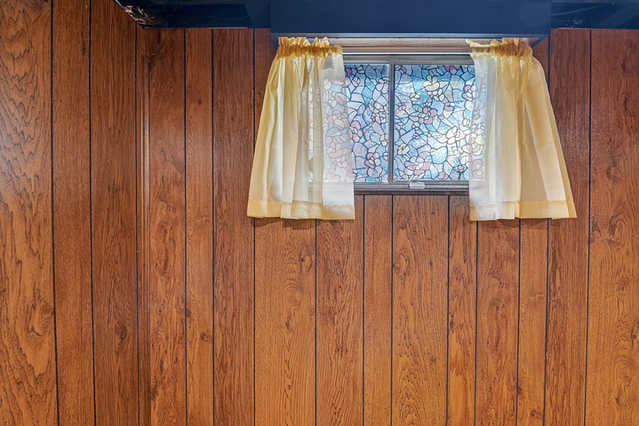 Charming basement window detail adding natural light and vintage character to the lower level.