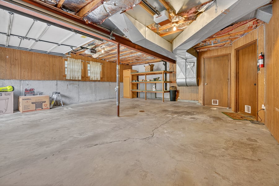 Massive garage space with high ceilings and plenty of room for parking, storage, or hobbies.