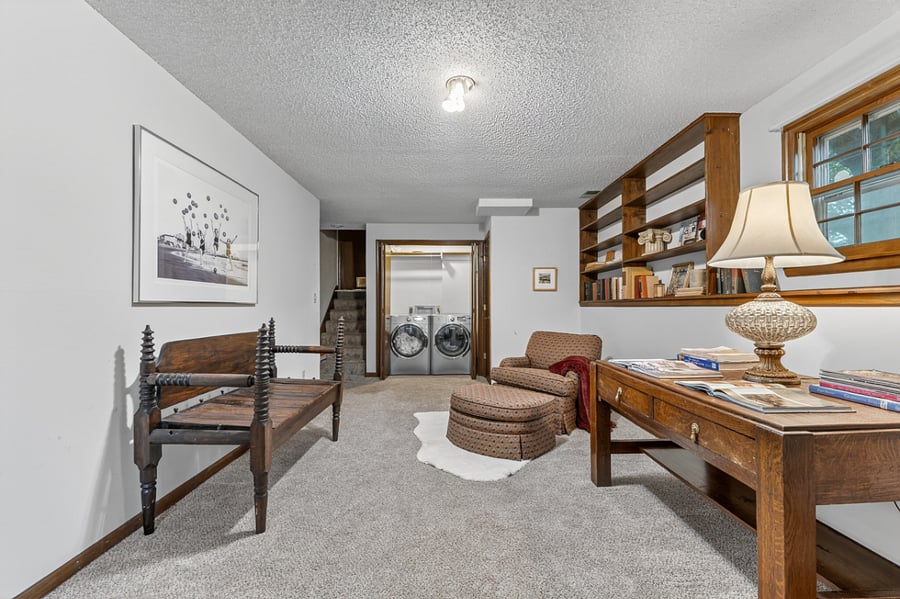Large multi use room with workspace potential, comfortable seating, and an inviting open layout.
