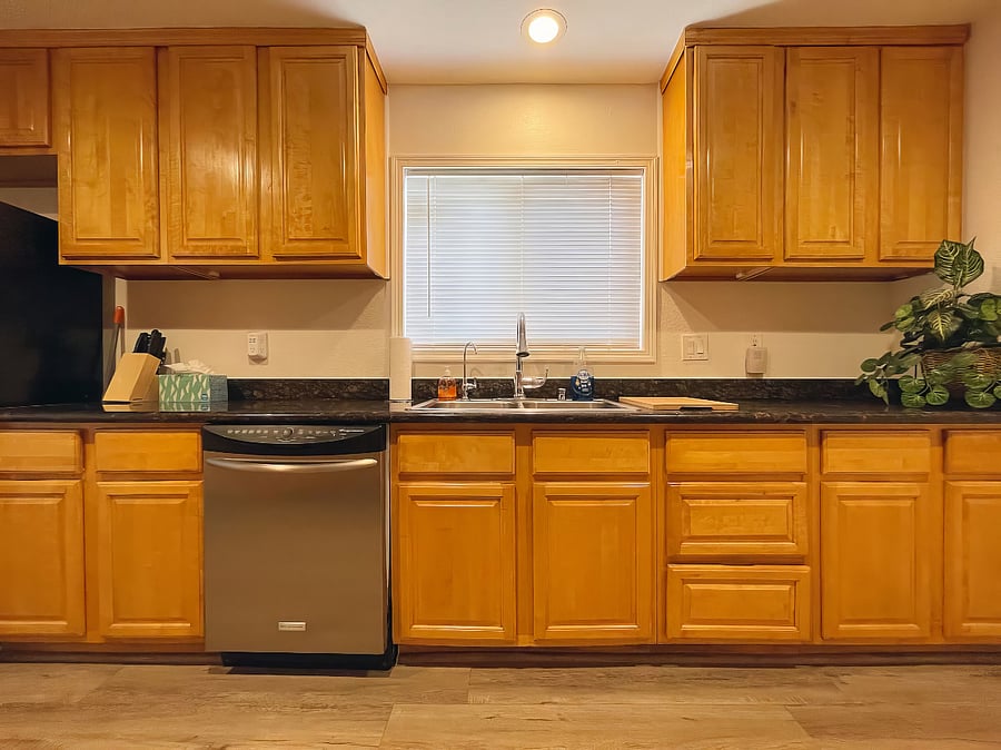 Kitchen with refrigerator, gas stove, oven, dishwasher, microwave, toaster, coffee maker, hot water kettle, and reverse osmosis purified drinking water system.