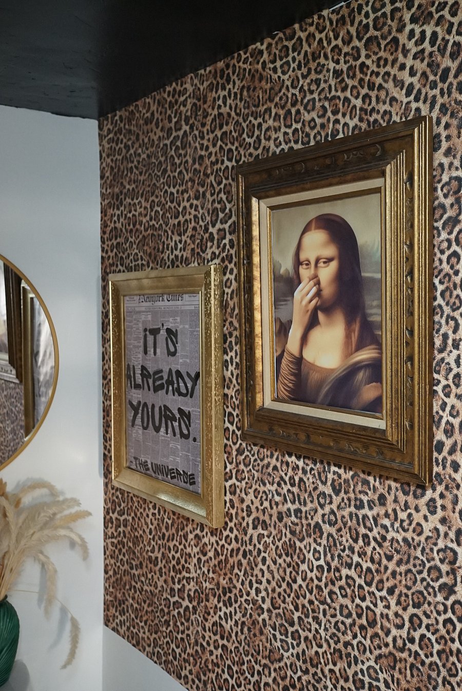 Downstairs (main level) Half Bathroom. Featuring custom leopard print wallpaper, black vertical tiling, & custom curated art to create a distinct visionary experience for guests + tenants. 