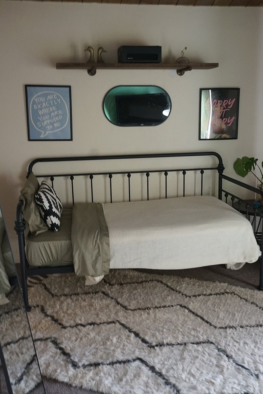 Bedroom 2 features a Twin Size Farmhouse style Bedframe with a tempurpedic mattress, stylish floor mirror, custom artframes, and a stylish wool rug to frame the space.  