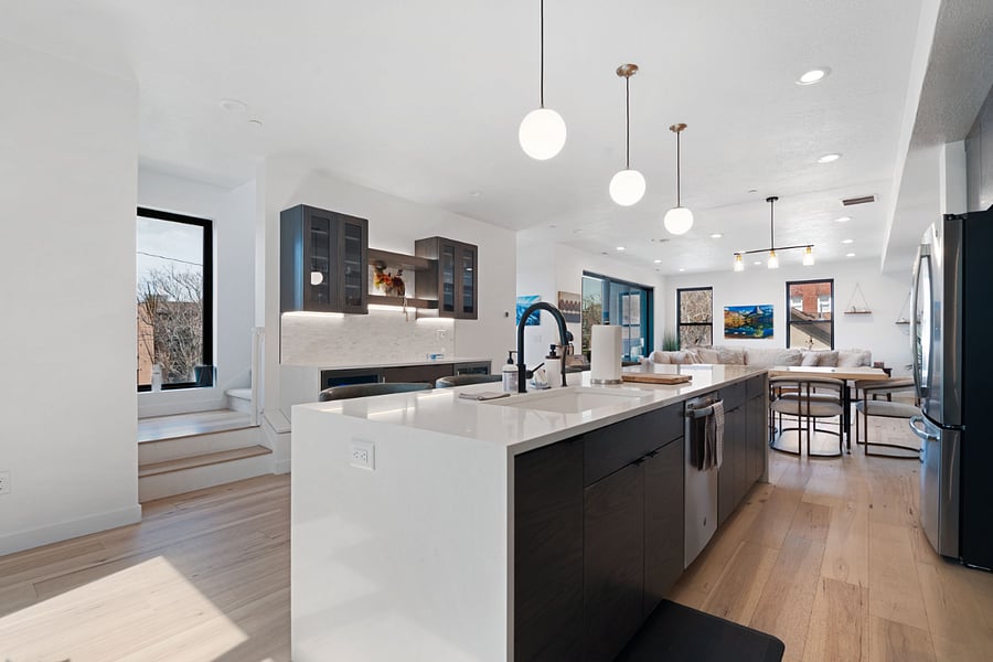 2nd floor: Living room, dining table, kitchen, bar, & balcony