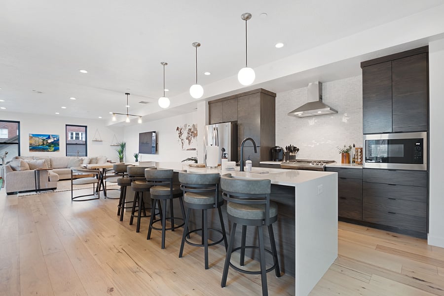 2nd floor: Living room, dining table, kitchen, bar, & balcony