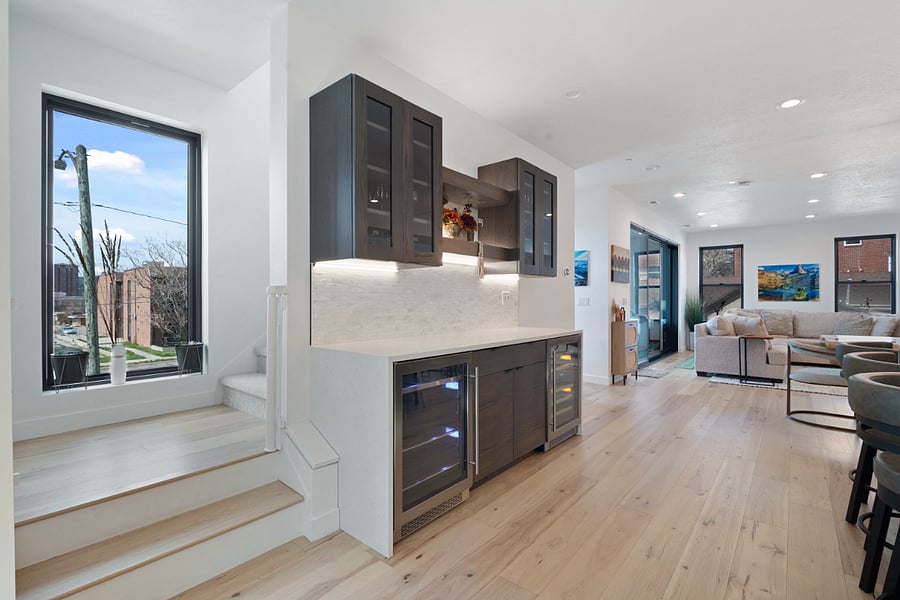 2nd floor: Living room, dining table, kitchen, bar, & balcony