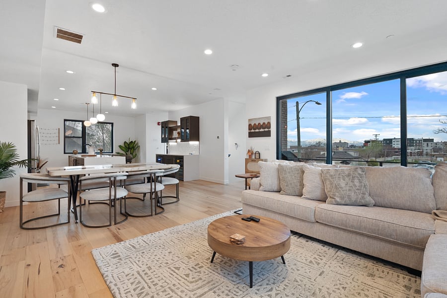 2nd floor: Living room, dining table, kitchen, bar, & balcony
